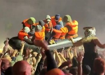 Banksy 'Launches' Migrant Boat Stunt At Glastonbury Festival, Which Has An 8-Mile-Long, 20ft-High Border-Wall